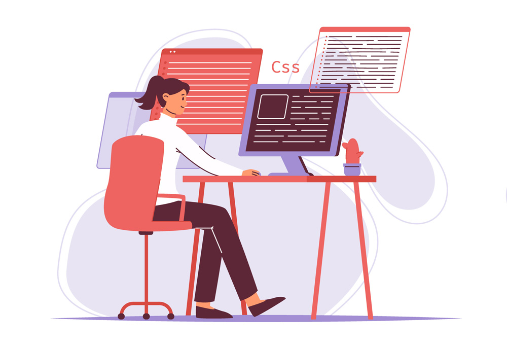 web designer sitting at her computer looking at a screen with CSS code on it