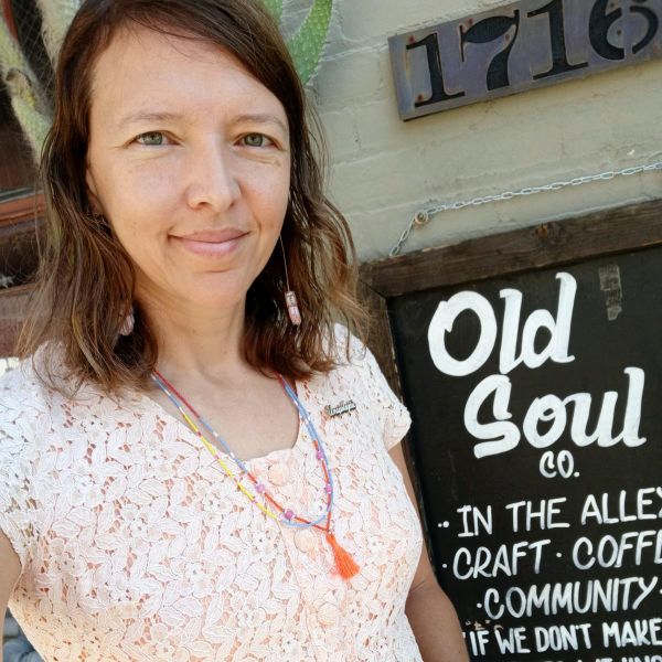 Jolinda in front of sign that reads "Old Soul Co."