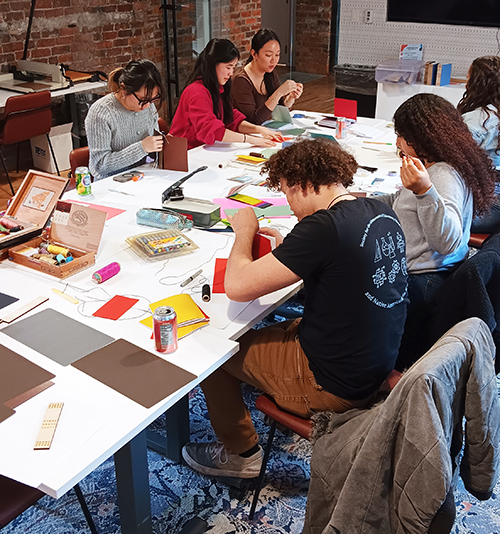 Group of people in a bookmaking workshop