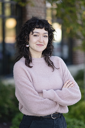 Jenna Marbukh, graphic designer, standing outside a business office